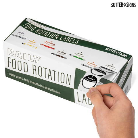 Hand holding box of Removable 1 Inch Day Of The Week Date Dots For Food Storage Meal Prep Labels In A Dispenser Box 7000 Food Container Labels