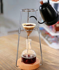 Skip The Coffee Shop Line With This Adjustable Cold Brew Drip Tower Featuring A Precision Flow Valve And Durable Heat Resistant Stainless Rack For Silky Homemade Sips in use, pouring water over coffee grounds.