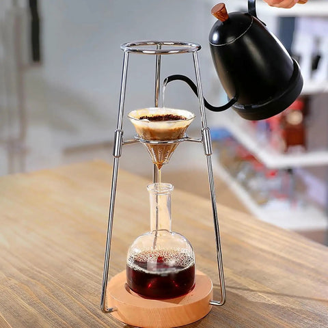 Skip The Coffee Shop Line With This Adjustable Cold Brew Drip Tower Featuring A Precision Flow Valve And Durable Heat Resistant Stainless Rack For Silky Homemade Sips in use, pouring water over coffee grounds.