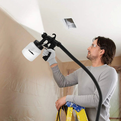 Man using High Power HVLP Electric Paint Sprayer With 800 Milliliter Per Minute Output on ceiling, home project
