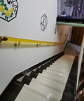 Clear Acrylic Stair Handrail With Dang Sturdy Gold Wall Brackets For Interior Or Exterior Steps on a modern staircase.
