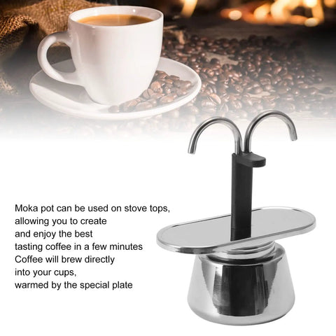 Stovetop Espresso Maker Real Deal Silver Stainless Steel Two Cup Italian Brew Pot With Dual Spout Handle Solid Camping And Everyday Coffee Gear For Your Morning Grinds with steaming coffee cup in background.