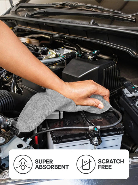 Grey microfiber cleaning cloth, close-up view, used on car engine bay; 12x12 inch, reusable, scratch-free