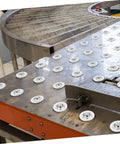 Industrial setup with Stainless Steel Mounted Ball Bearings and Transfer Bearings With Protective Cover for heavy-duty movement.