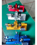 Compact Mini Metal Lathe For Benchtop Use With 3 Jaw Chuck And Tailstock in red, yellow, blue, and silver colors on a green surface.