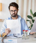 A man examining documents while using a Totally Versatile Rubber Date Stamp With Rotating Mechanism For Scrapbooking And Office Tasks.