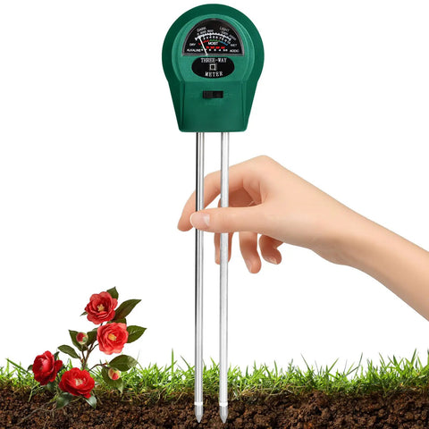Hand holds 3 In 1 Soil Moisture Light And pH Tester Battery Free Gardening Tool for indoor and outdoor use above soil with roses.