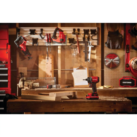 V20 Cordless Impact Driver Kit with 1/4 Inch Quick Release Chuck on a workbench in a tool-filled workshop