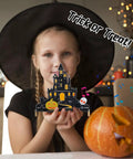 Child holding Halloween Music Castle Soldering Kit For Teens And Adults With Dual Lighting Modes And Spooky Sound
