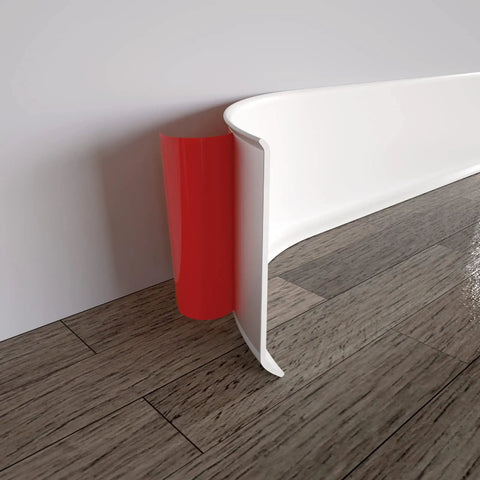 Close-up of Self Adhesive Vinyl Wall Base Molding Trim 4 Inch Wide 20 Feet Long White Cove Base on wood floor, showing peel and stick feature.