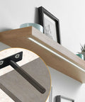 Rock Solid Four Inch Floating Shelf Brackets Set Of Four In Matte Black featuring invisible mounting on a wooden shelf.