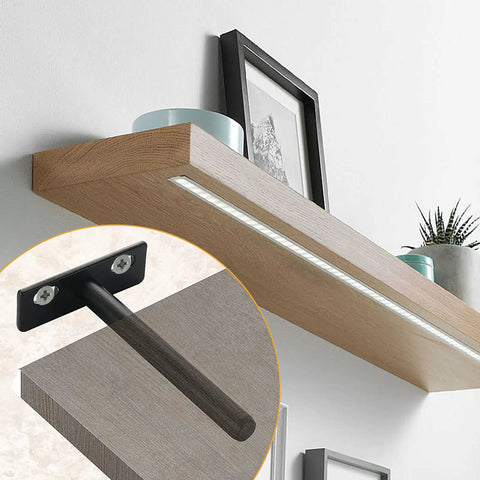 Rock Solid Four Inch Floating Shelf Brackets Set Of Four In Matte Black featuring invisible mounting on a wooden shelf.