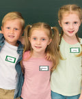 Children wearing 400 Soccer Name Tag Stickers Set In Green And Black With 4 Designs Adhesive Label Decals in classroom setting.
