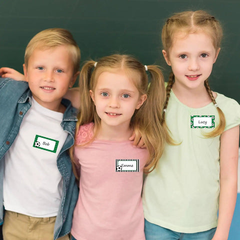 Children wearing 400 Soccer Name Tag Stickers Set In Green And Black With 4 Designs Adhesive Label Decals in classroom setting.
