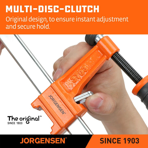 Close-up of orange Jorgensen steel bar clamp (F-clamp) being tightened by hand for woodworking.
