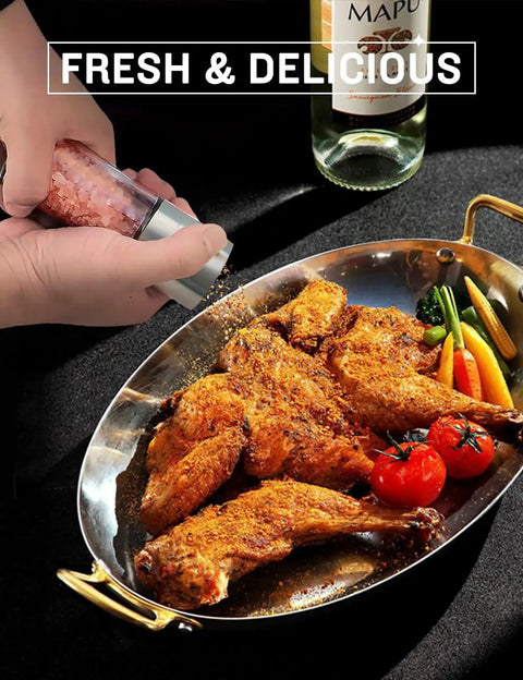 Refillable Pepper Grinder And Salt Shaker Set With Adjustable Coarseness being used on roasted chicken in a pan.