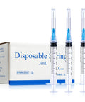 The Real Deal 3Ml Sterile Syringes With Sharp 23G 1 Inch Needles, Leak Proof Luer Lock, 100 Count Disposable Box, Heavy Duty Polypropylene For Medical And Lab Use, with three syringes beside the packaging.