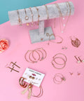 Must Have 38 Piece Jewelry Set For Women With Four Necklaces Ten Bracelets And Twenty Four Layered Ball Hoop Earrings Lightweight Alloy Fashion Jewelry For Everyday Glam Eco Friendly And Colorfast Gift Ready displayed on pink background