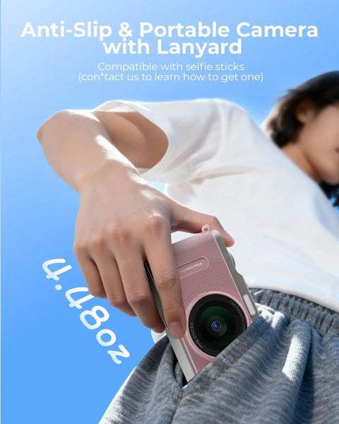 Fire Pink Wifi Digital Camera For Kids Featuring Switchable Dual Lenses And Crisp 4K Capture Point And Shoot Option With Sixteen X Zoom Anti Shake Tech Super Portable Compact Design Prime Gift For Cool Teens in hand, partially in pocket.