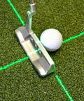 Solid Side Laser Putting Trainer For Righty Golfers Groove Plus Alignment Tool on practice green with white golf ball.