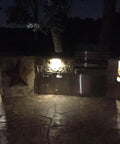 Outdoor area at night with Three LED Landscape Lights With Bracket In Textured Architectural Bronze Finish 4 Pack lighting a patio