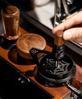 Hella Smooth 58mm Wdt Distribution Tool For Espresso Bars Featuring ten adjustable needles and walnut grip in use.