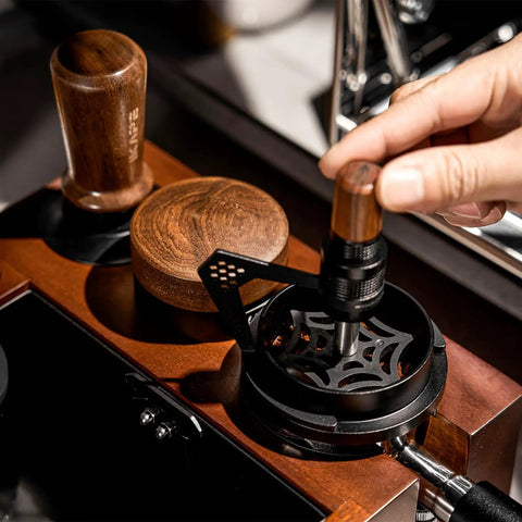 Hella Smooth 58mm Wdt Distribution Tool For Espresso Bars Featuring ten adjustable needles and walnut grip in use.