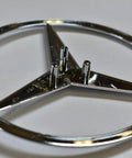 Mercedes-Benz Rear Hatch Emblem Genuine OEM 1648170016 silver replacement, showing back pins, durable, for specific models.