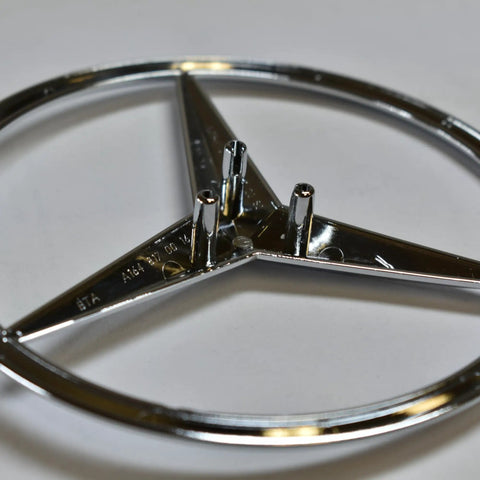 Mercedes-Benz Rear Hatch Emblem Genuine OEM 1648170016 silver replacement, showing back pins, durable, for specific models.