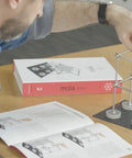Person using Structural Kit 2 Magnetic Modular System for engineering education with 145 pieces on table.