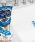 Foaming Garbage Disposer Cleaner Twenty Pack With Lemon Scent on towel beside sink, showing packaging of cleaner packets.