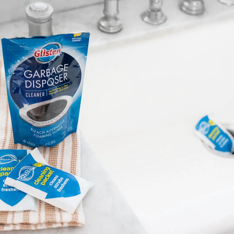 Foaming Garbage Disposer Cleaner Twenty Pack With Lemon Scent on towel beside sink, showing packaging of cleaner packets.