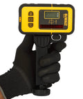 Person holding Battery-Free Line Laser Detector For DW088K And DW089K With Backlit LCD, Narrow Or Wide Accuracy, Heavy-Duty Clamp.