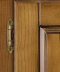 Self Closing Hidden Kitchen Cabinet Hinge Three Eighth Inch Inset Antique Brass installed on wood cabinet