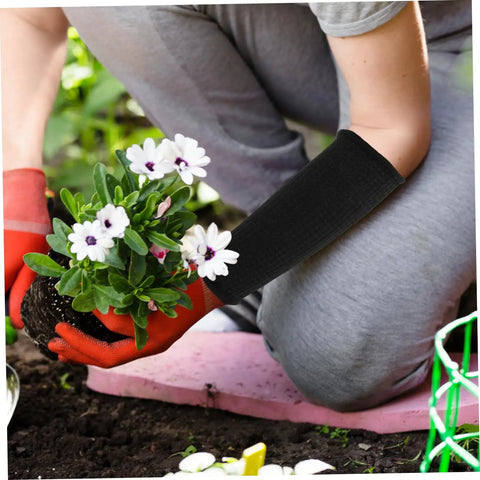 Person wearing Super Heavy Duty Cut Resistant Arm Sleeves while planting flowers, providing forearm protection during gardening.