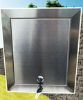 Rock Solid Waterproof Stainless Steel Lockable Access Door With Secure Key, shown front view against a landscaped background.