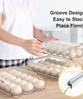 Person stacking a 54 Egg Rolling Organizer for Refrigerator with 3 Layers, Clear Egg Storage Box with Lid, showcasing groove design.
