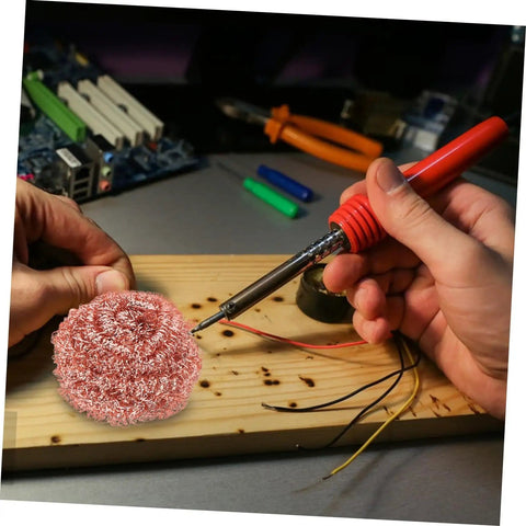 Hands using Six Pack Soldering Tip Copper Wire Sponge Balls For Efficient Tin Removal And Clean Tip during electronics repair.