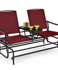 Two Person Swing Glider Chair With Center Tempered Glass Table Outdoor Patio Rocking Loveseat On Steel Frame With Breathable Mesh Fabric Perfect Balcony Or Poolside Seating In Burgundy, shown with two seats and a table holding drinks