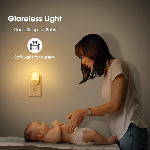 Woman caring for baby with Two Pack LED Night Lights Plugs Into Wall, Dimmable With Light Sensor, Auto On Off, 3000K soft white.