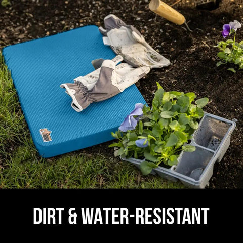 Extra Thick Supportive Foam Kneeling Pad 2 Pack on soil with gardening gloves and flowers, dirt and water resistant.