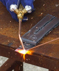 Welding handle with a hose connection and front valves brass ribbed forged handle built tough, in use on metal welding surface