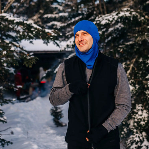 Man in blue hat wearing Heavy Duty Kick Ass 100 Percent Merino Wool Men Vest Expedition Grade Heavyweight in snow.