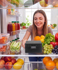 Woman placing 16 Slot 30ml Vial Case For Bac Water And Peptide Reconstitution in fridge, surrounded by fresh produce.