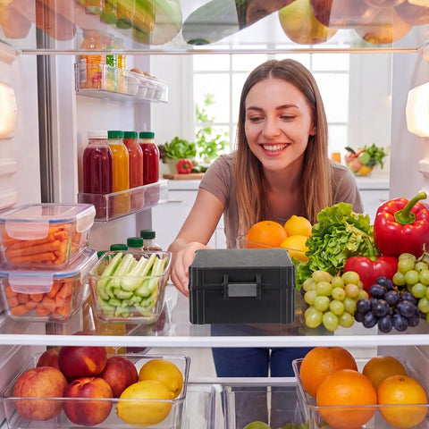 Woman placing 16 Slot 30ml Vial Case For Bac Water And Peptide Reconstitution in fridge, surrounded by fresh produce.