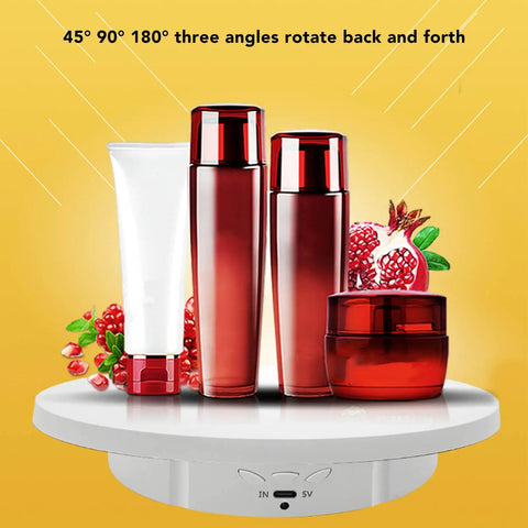 Upgrade Your Product Shots With This Slick White Electric Turntable For Sparkly Jewelry Displays Featuring 360 Degree Glass Rotation And A Super Stable Motor Made For Pro Quality Photos Every Single Time. Red cosmetic bottles displayed on a white electric turntable.