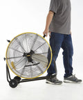 Person moving Industrial Drum Fan 24 Inch High Velocity 8800 CFM Three Speed Heavy Duty Metal Air Circulator with handle