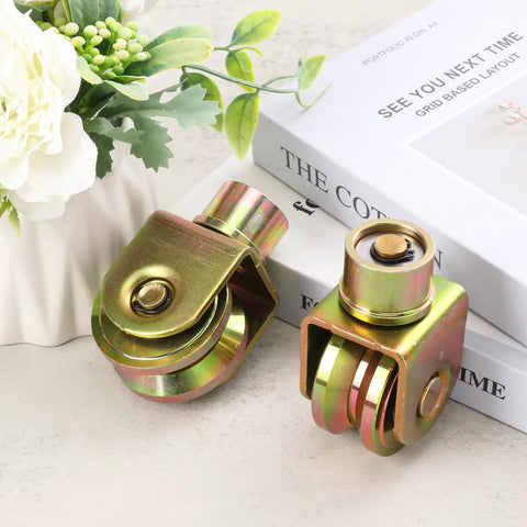 4 Pack 2.5 Inch Sliding Gate Wheels With 360 Degree Rotational Stem And V Groove Caster, displayed on a table with decorative items.