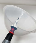 Front view of clear plastic dust bowl attachment for hole saws with drill-bit adapter and red collar