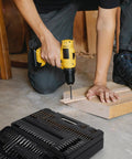 Person using a drill from the 400 Piece Drill Bit Set With Drawer Case For Metal Wood And Masonry Pro Grade Drill And Screwdriver Bit Kit For Quick Drilling And Driving Perfect For DIY Projects, with open case visible.